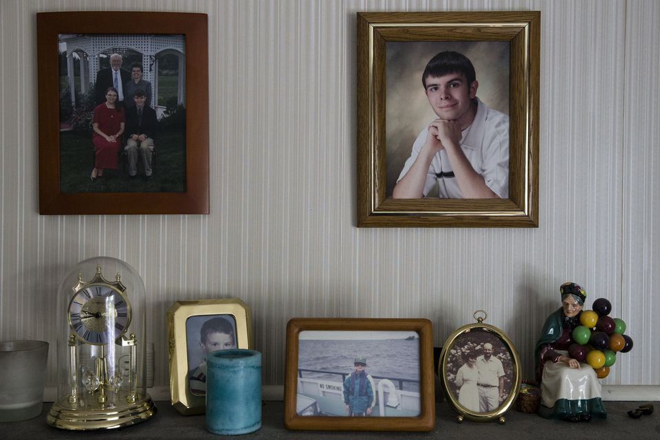 A photo of Brian Simpson is on a wall at his parents’ home. He died of an overdose.(KEITH BEDFORD/GLOBE STAFF/FILE)
